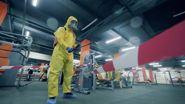 Disinfector cleans gym during coronavirus pandemic.