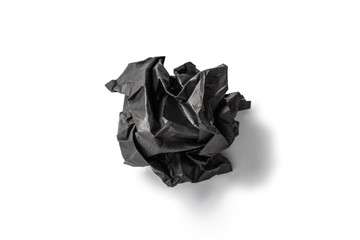 Black crumpled paper on a white background.