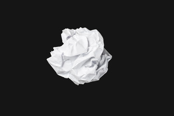 White throwing paper lies on a black background.