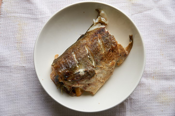 Piece of fish in a white plate