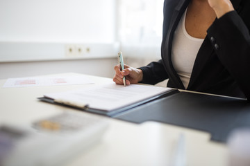 Businesswoman signing contract