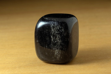Black onyx polished gemstone from China over a wooden table