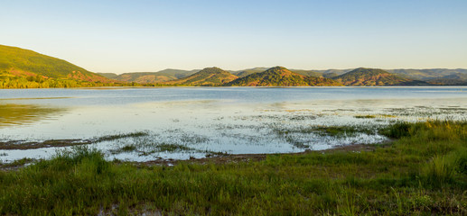Aerial panorama of Lac du Salagou in the early morning in summer in Hérault in Occitania, France