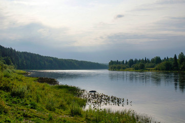 Calm river view at sunset and light cloudy cover