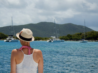 Woman wearing a hat on a summer  sailing vacation in the British Virgin Islands