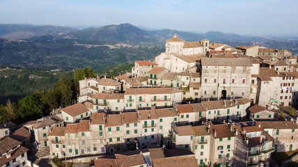 Fototapeta na wymiar Capranica Prenestina, aerial view of the ancient city, dominated by the prestigious dome, in the background the Apennine mountains