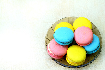 Closeup of Colorful french Sweet Pastries Macaroons on glass plate, for advertising with copy space, isolated on white background.