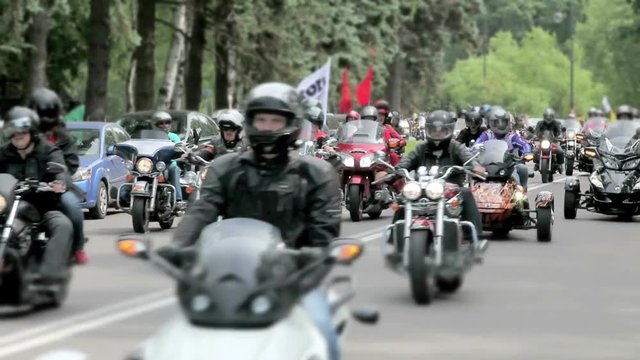 cowd of bikers on motorcycles traveling on the road, parade of motorcyles