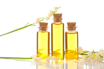 Essence of flowers on table in beautiful glass jar