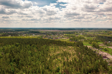 Fototapeta na wymiar Aerial view of Ukrainian green landscape in summer sunny day. Beautiful countryside panorama in the summertime. Natural foliage background.