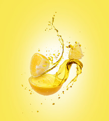 Juice splashes out from sliced lemon on yellow background