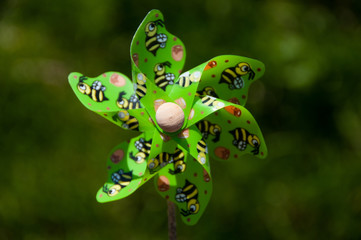 Colorful windmill on natural background. Plastic colorful toys. Summer. 