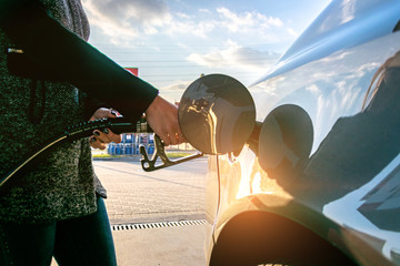 Filling car petrol. Pump gas fuel at gasoline oil station for nozzle tank. Black handle of the...