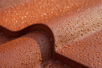 Metallic roof with drops of water. Macro image.