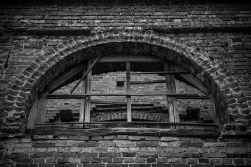 Fototapeta na wymiar An old wooden window in the wall of a ruined church