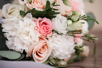 Obraz premium Perfect image with copy space for chic boho wedding magazines and websites, bohemian, fashion, florist. Flowers bouquet with nude roses and wedding rings. Copy space. Flowers background.