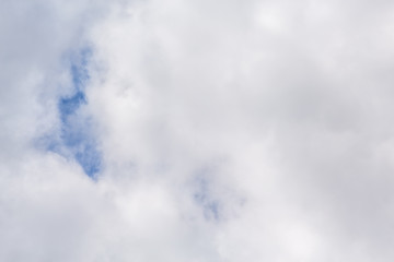 Fototapeta premium continuous clouds with a small hole through which the blue sky shines through