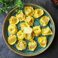 tortellini pasta stuffed ravioli Menu concept serving size. food background top view copy space