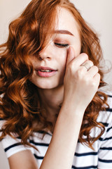 Obraz premium Close-up portrait of spectacular european lady wears silver ring. Joyful ginger girl posing with eyes closed.