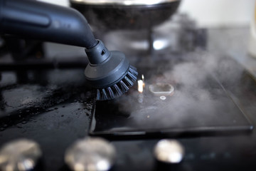 glass ceramic stove cleaning with a steam cleaner, house disinfection.