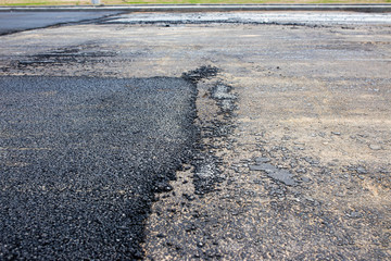 border of freshly and old asphalt on the road.