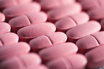 Rows of pink pills. Macro image.