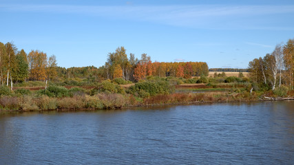 Fototapeta na wymiar Autumn landscape and a small lake