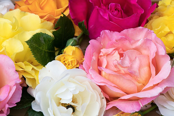 Lots of lush roses of different colors in bouquet