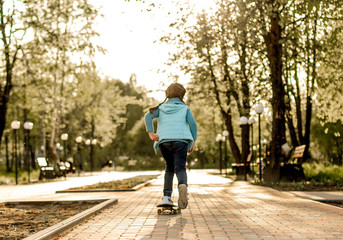 girl in the park on a skateboard in spring