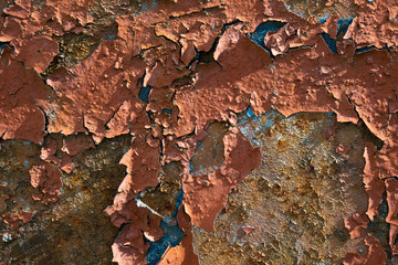 Old painted wall with peeled paint. Rusty metal wall with cracked paint. Abstract vintage background in post-apocalyptic style. 