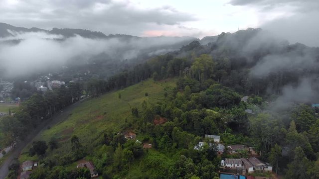 Aerial Drone Shot Flying by Cloudy Misty Foggy Lushoto village in Usambara Mountains. Remote Place in Tanga Province, Tanzania, Africa