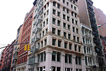 Buildings with fire escapes at an intersection with traffic lights in Midtown Manhattan, new York.