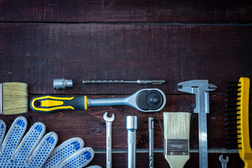 Construction tools on a wooden background. Space for your text. The view from the top