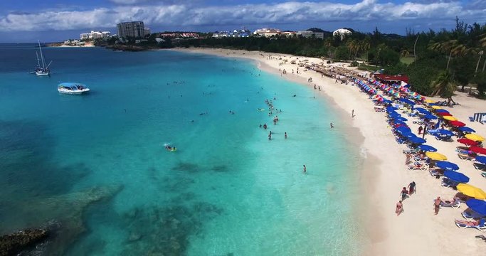 Aerial view of Maho beach with large crowd having fun on the beach.
