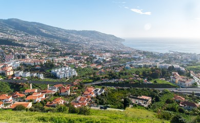 Fototapeta na wymiar View of Funchal city, the surrounding hills and the ocean from Pico dos Barcelos lookout point, Madeira