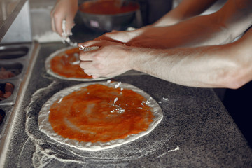 Chef prepare the pizzaa. Man in a white uniform