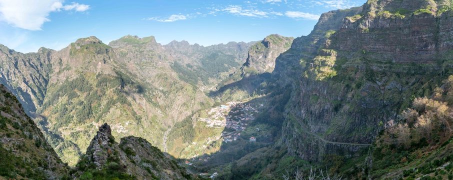 Panorama of Curras Das Freiras town surrounded by hills and mountains from the viewpoint at Eira do Serrado, Madeira