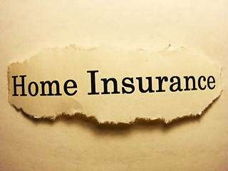 Torn paper with home insurance text. Home insurance concept.