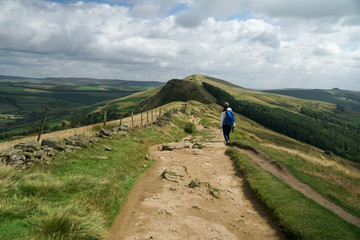 A solo female traveller hiking in the mountain in England, Peak District National Park 