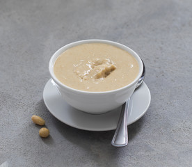 Vegan nut paste, peanut paste in a  bowl on a light background
