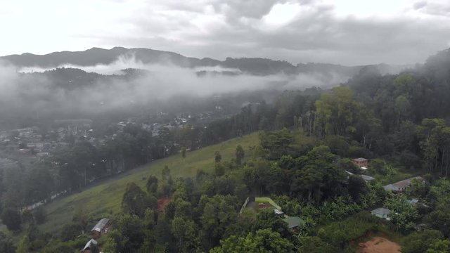 Aerial Drone Shot Flying by Cloudy Misty Foggy Lushoto village in Usambara Mountains. Remote Place in Tanga Province, Tanzania, Africa