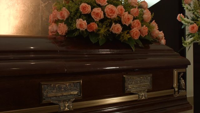 coffin with flowers in chapel