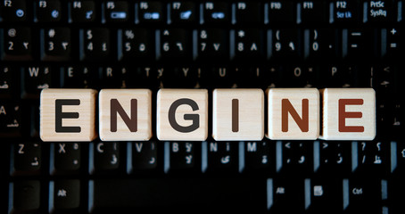 Engine - concept text on wooden cubes on background black keyboard
