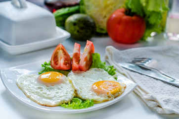 Fried eggs from two eggs on a plate
