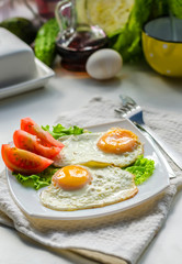 Fried eggs from two eggs on a plate