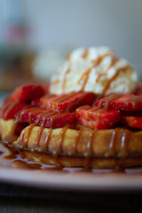 Belgian waffles with strawberrys and caraml syrup