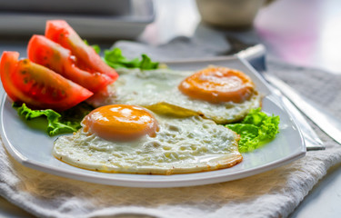 Fried eggs from two eggs on a plate