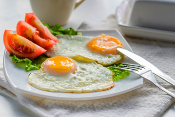 Fried eggs from two eggs on a plate