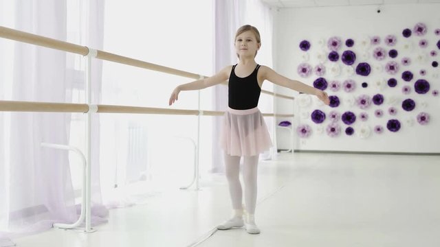 Little graceful girl practicing ballet in the Studio