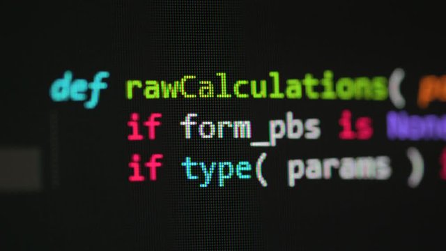 Partially blurred code on the computer screen. Macro video with distinctly distinguishable pixels.